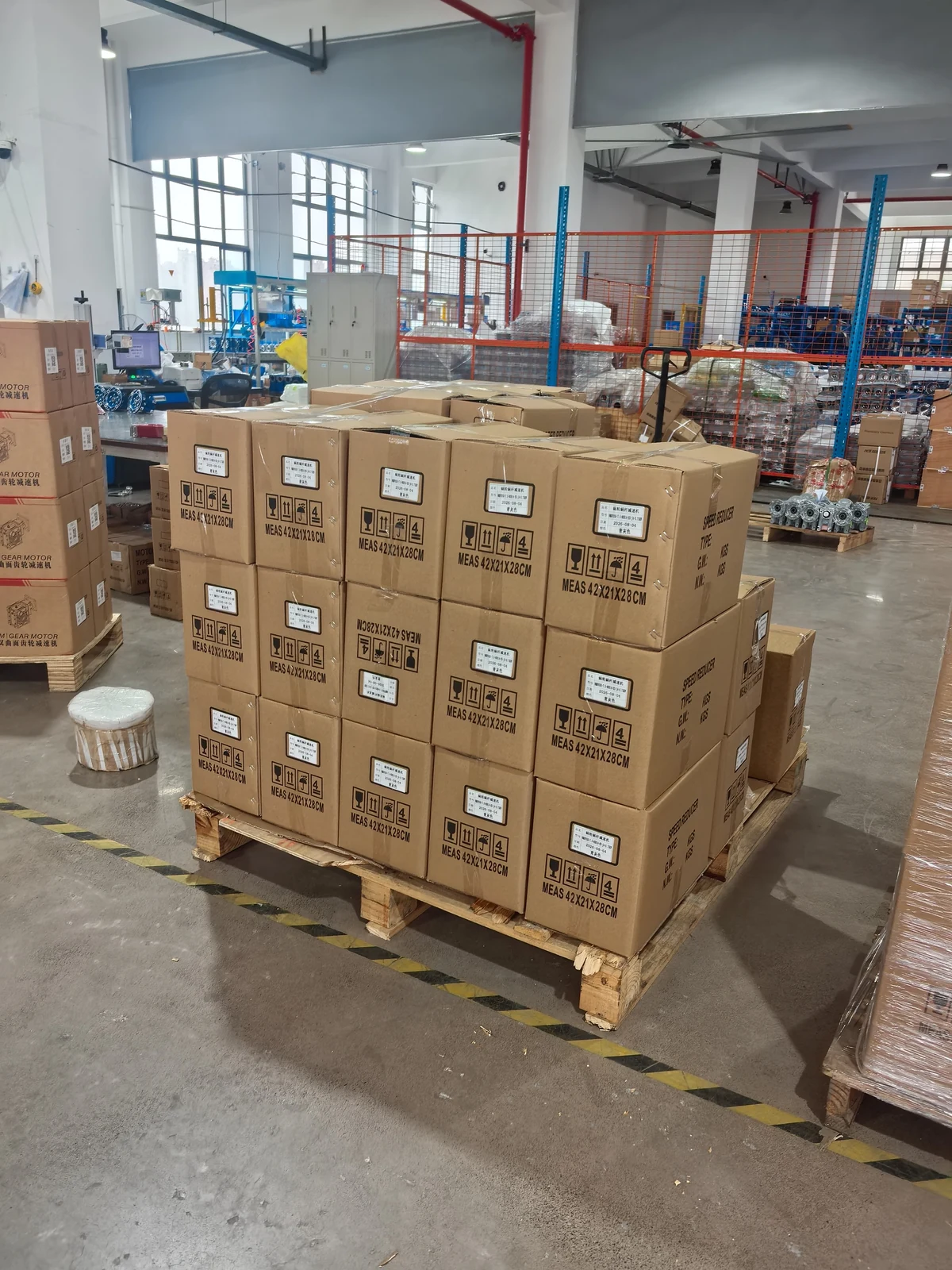 SMK gear motors packed in labeled export cartons on wooden pallets