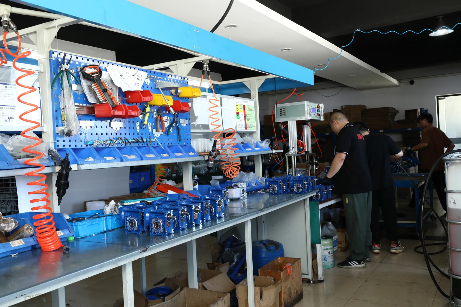 Workers assembling NMRV worm gearboxes at dedicated SMK factory workstations